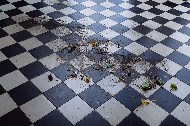 Tiled floor with dirt and crumbs